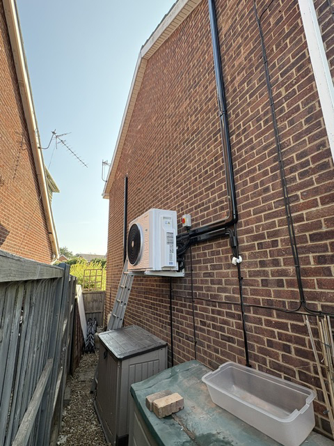  Worcester Bosch multi Split AC system on an outside wall of a residential property in Poole